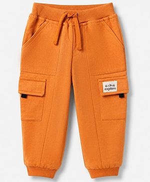 Babyhug Cotton Terry Full Length Knit Track Pant with Ribbed Waist and Explore Patch in Rust Orange