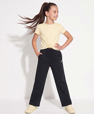 Pine Active Knit Full Length Solid Flared Pant with Logo Print in Black