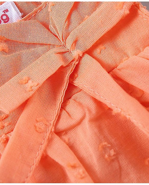Babyhug Sleeveless Swiss Dot Woven Top With Bow & Frill Detailing - Peach