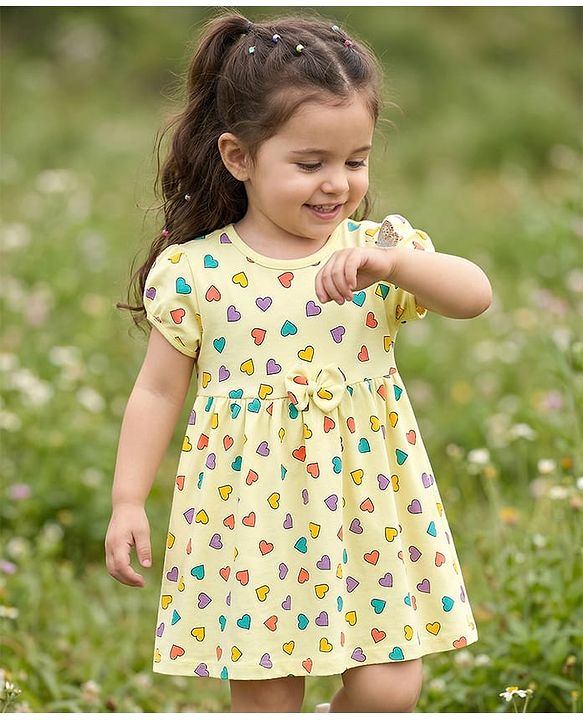 Babyhug 100% Cotton Knit Half Sleeves Hearts Printed Frock With Bow Applique - Yellow