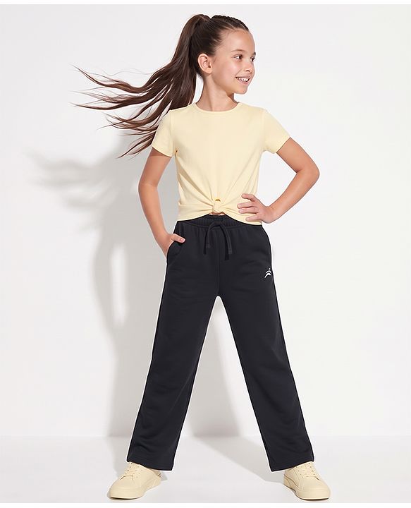 Pine Active Knit Full Length Solid Flared Pant with Logo Print in Black