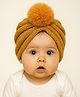 The little lookers Soft Woollen Knitted Pom Pom Appliqe Detailed Turban Cap - Beige - Circumference 36 Cm