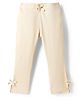Babyhug Lycra Knit Full Length Striped Leggings With Bow Applique - Beige