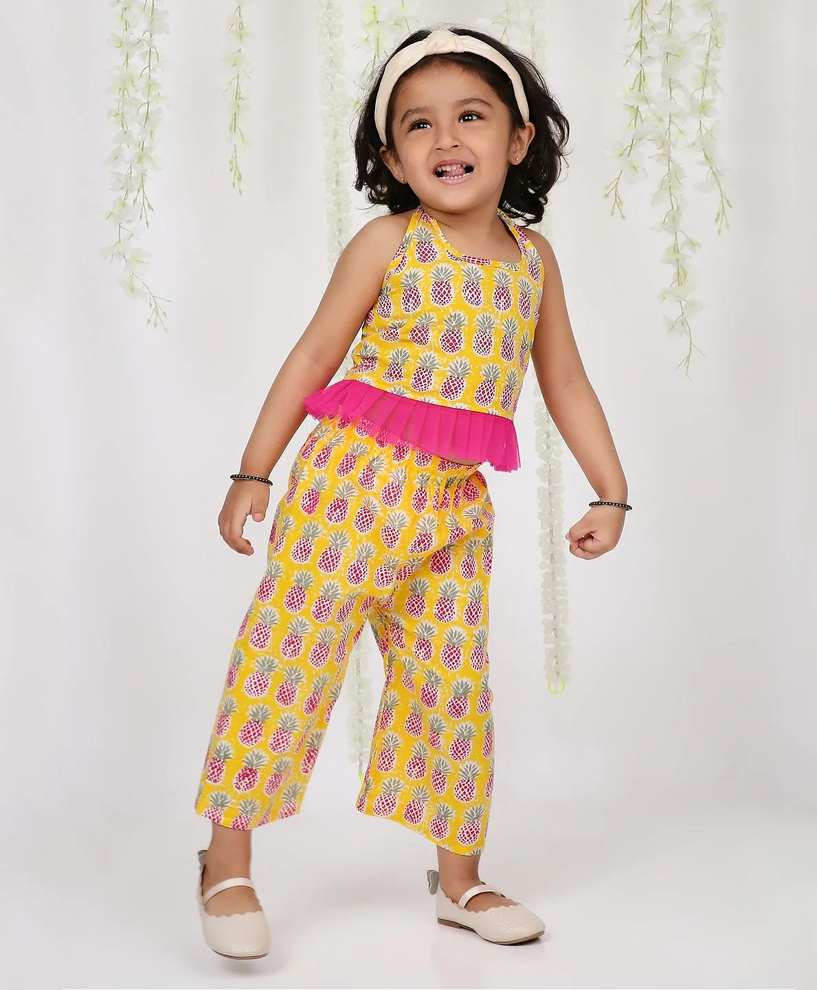 https://cdn.fcglcdn.com/brainbees/images/products/kid1-pina-colada-theme-sleeveless-all-over-pineapple-printed-frill-mesh-hem-detailed-top-with-coordinating-pant-yellow-13255731a.webp