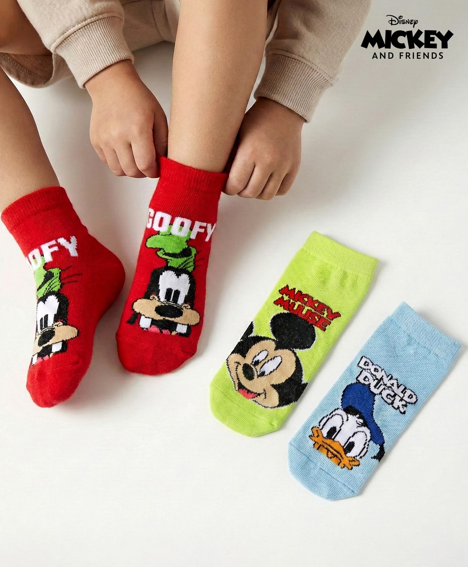 Cute Walk by Babyhug Disney Knit Ankle Length Anti Bacterial Socks With Mickey Mouse & Friends Print Pack Of 3 - Red Light Blue & Yellow